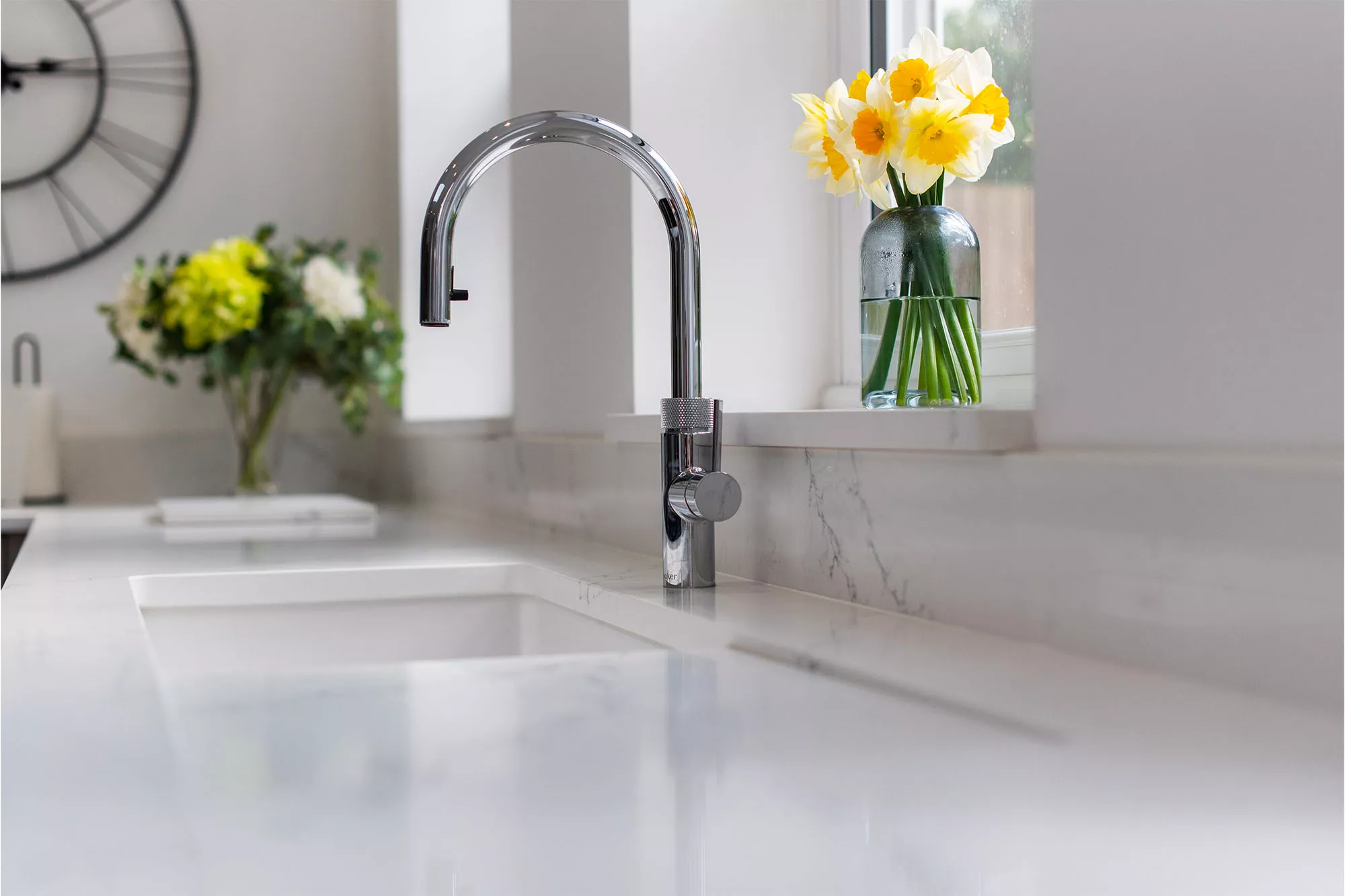 quooker tap on a worktop with daffodils in the window