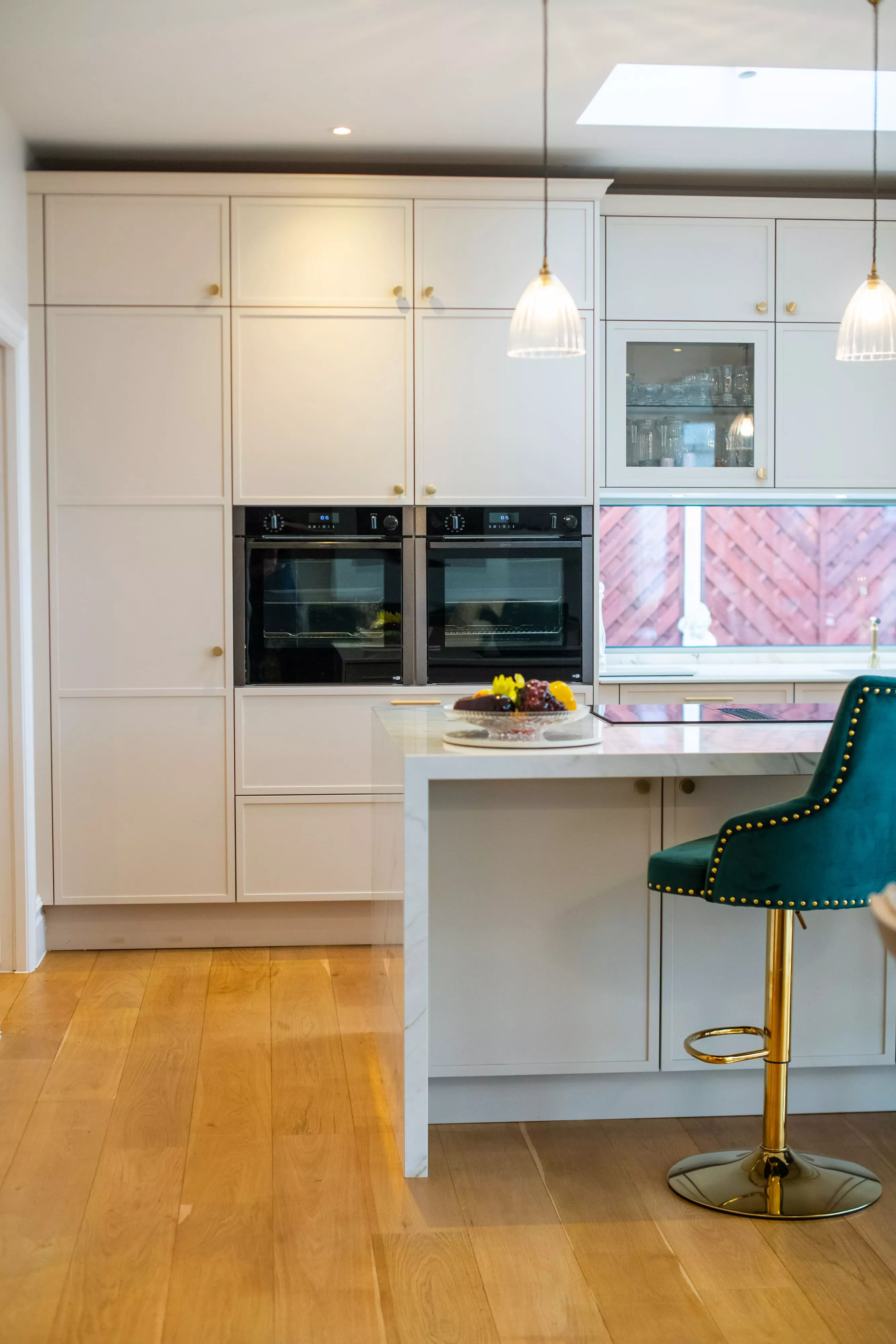 Shaker style kitchen with oven and chair