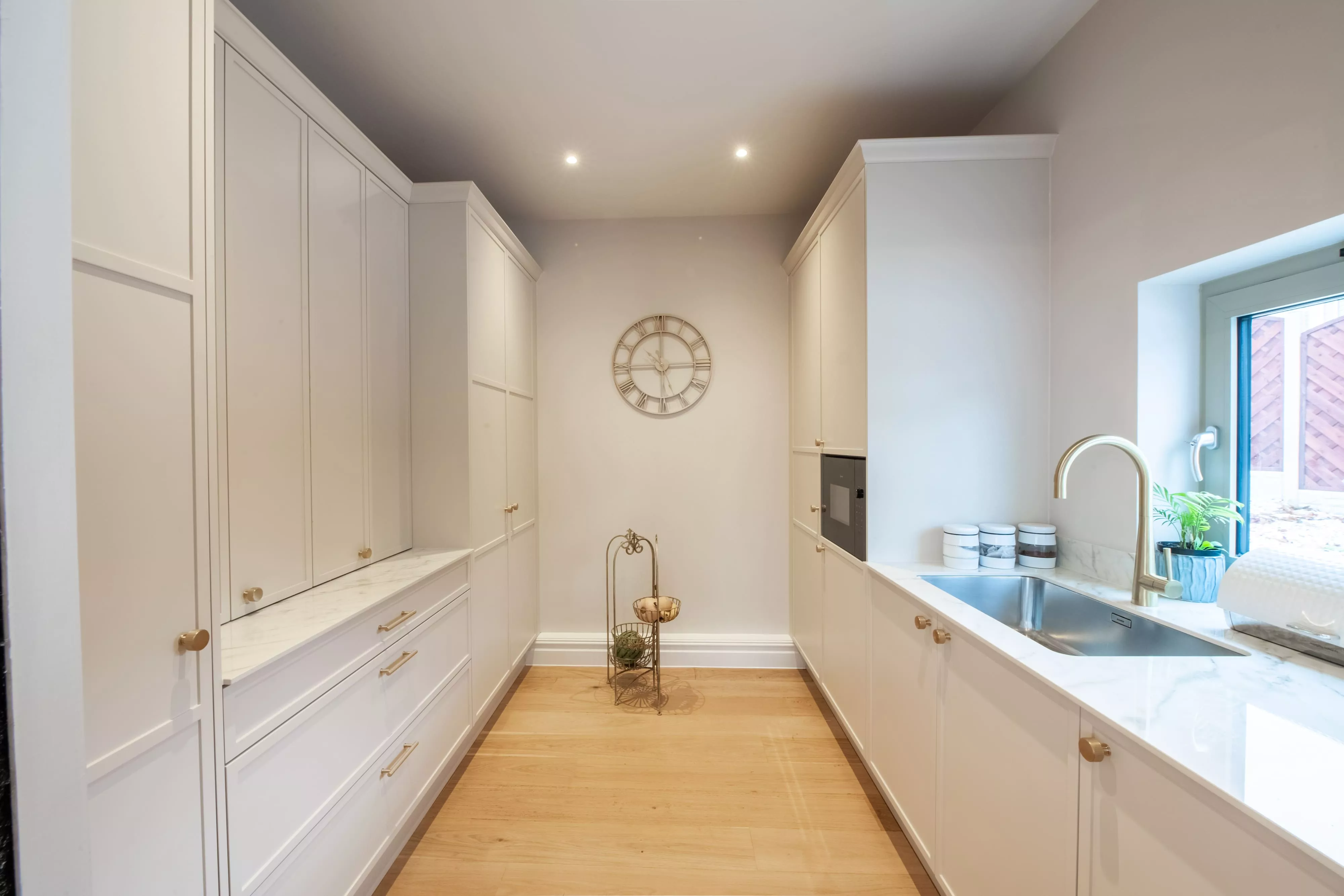 full view shaker style kitchen in white with gold accents