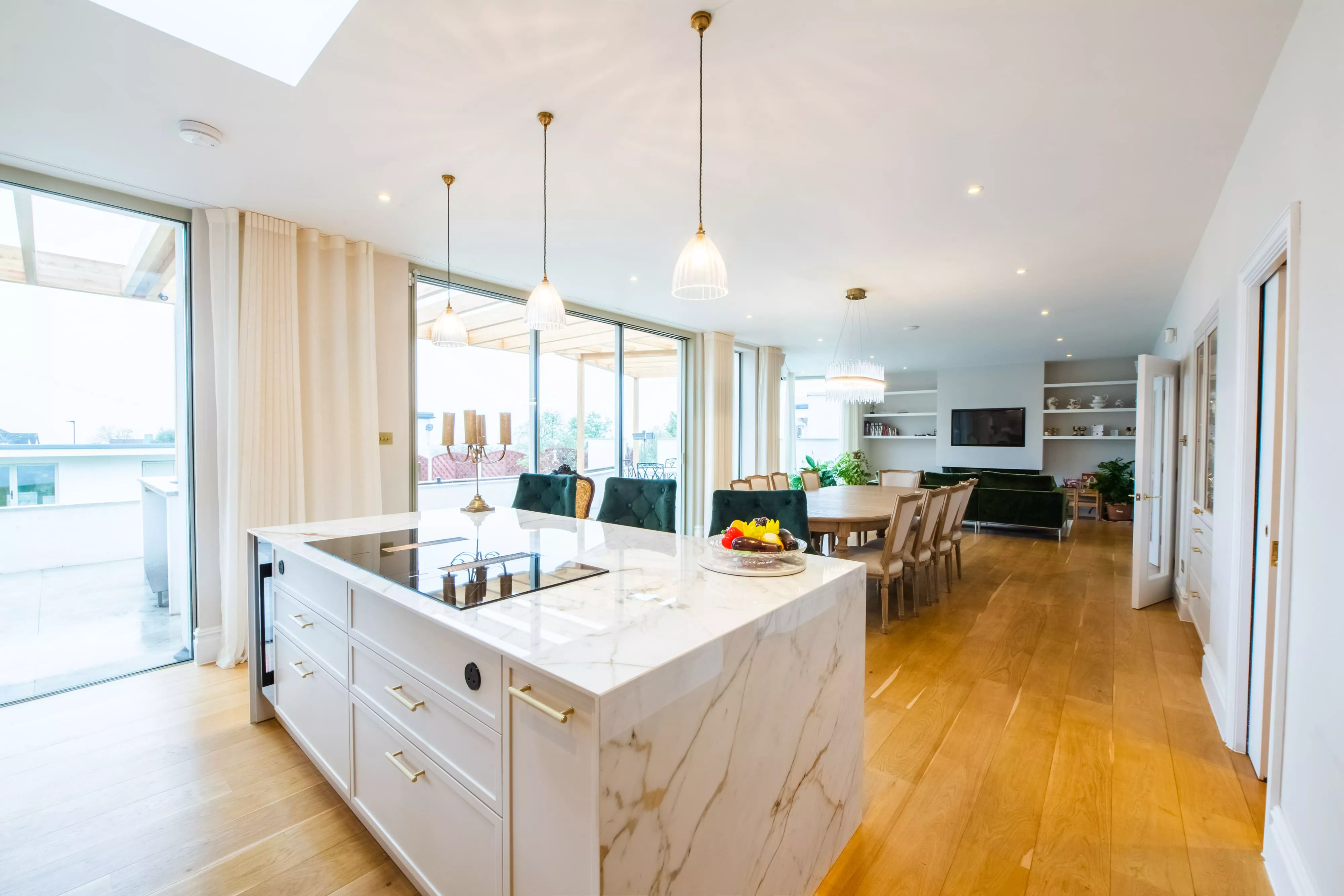 white marble shaker style kitchen looking out to dining area