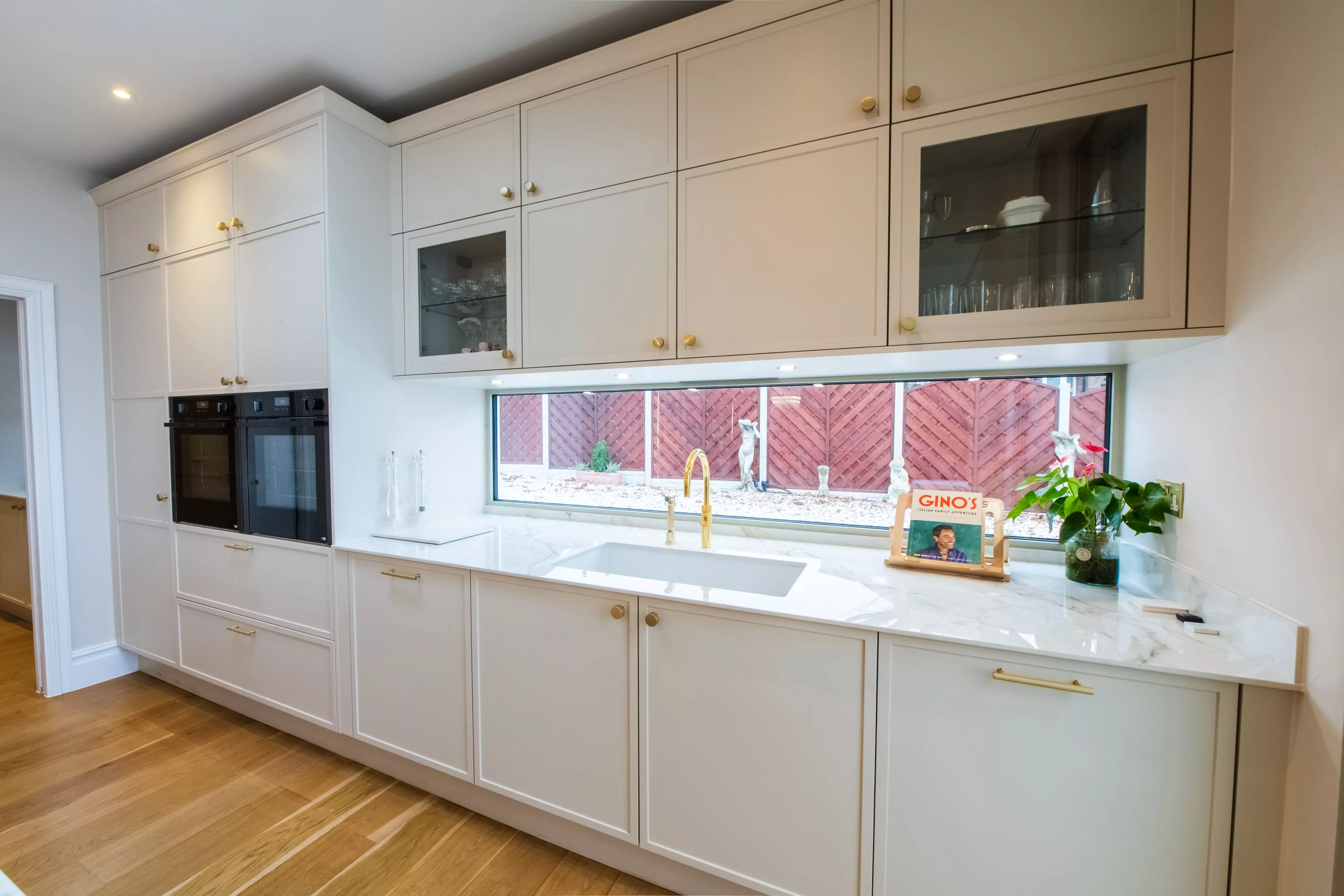 side view shaker style kitchen in white with gold accents